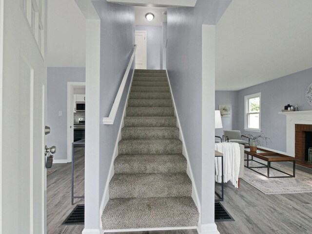 315 S Southampton Ave, Columbus, OH 43204 - staircase featuring wood finished floors and a fireplace