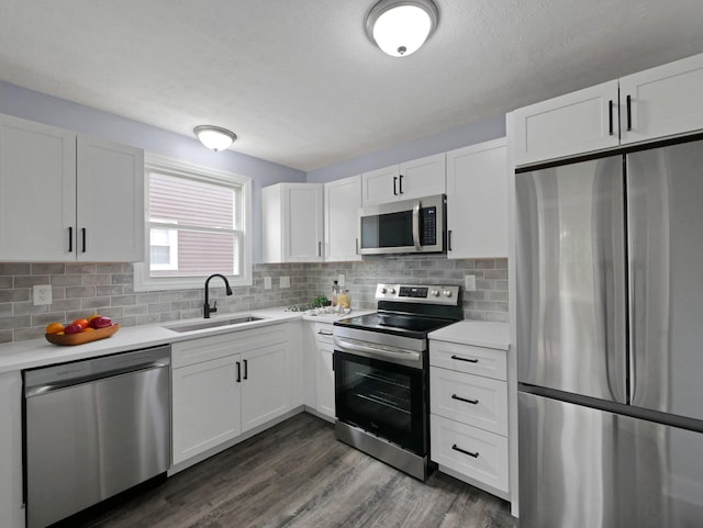 315 S Southampton Ave, Columbus, OH 43204 - kitchen featuring stainless steel appliances, light countertops, dark wood-style floors, white cabinets, and a textured ceiling