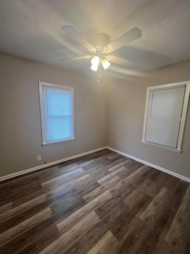 2769 Mcguffey Rd, Columbus, OH 43211 - empty room featuring dark wood finished floors, a textured ceiling, and ceiling fan