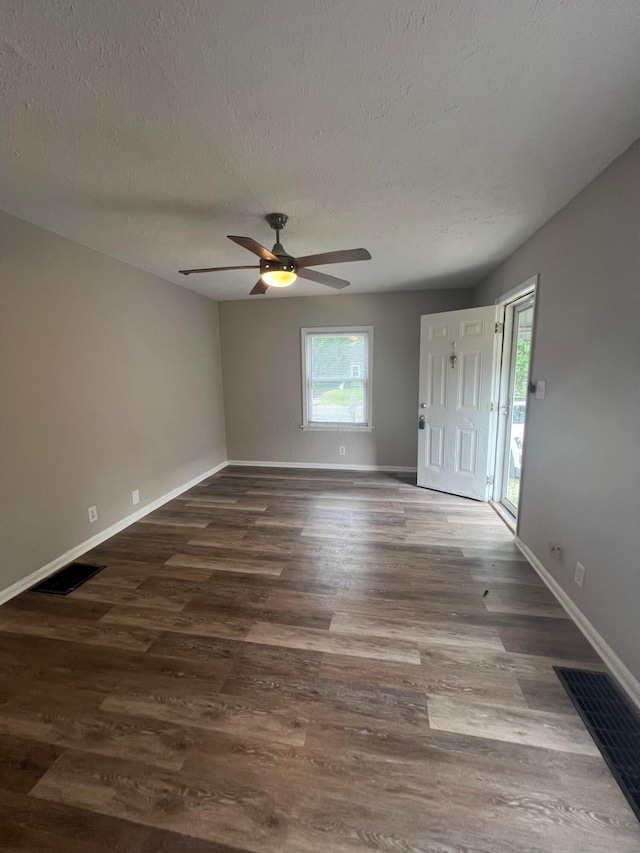 2769 Mcguffey Rd, Columbus, OH 43211 - unfurnished room with wood finished floors, ceiling fan, and a textured ceiling
