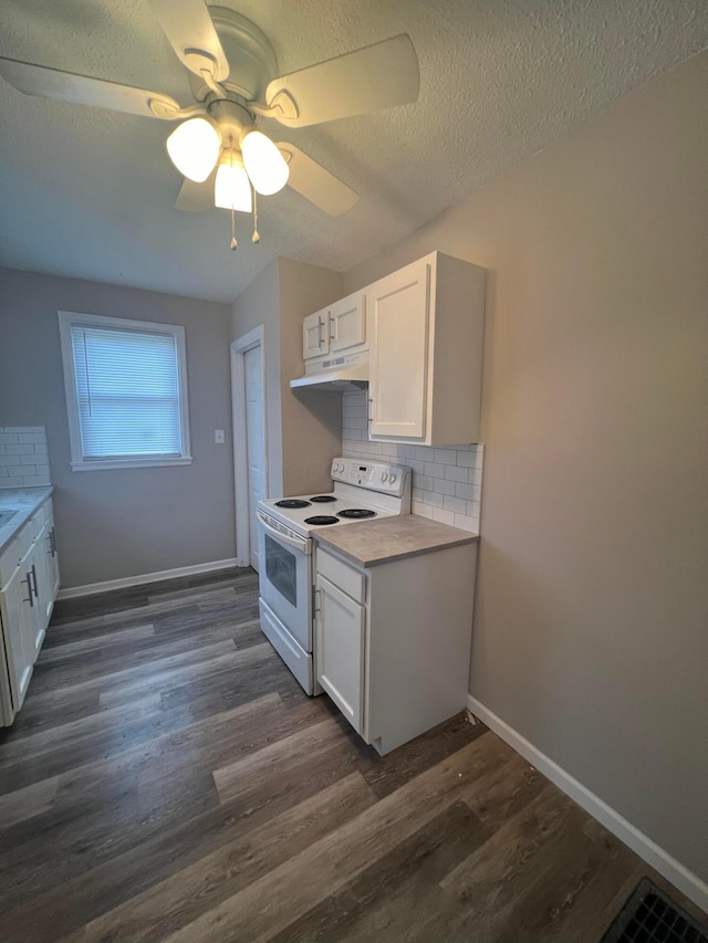 2769 Mcguffey Rd, Columbus, OH 43211 - kitchen with white electric stove, under cabinet range hood, white cabinets, decorative backsplash, and a textured ceiling