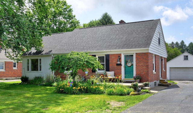 175 Pierson Blvd, Newark, OH 43055 - cape cod house featuring an outbuilding, brick siding, a chimney, a front lawn, and a detached garage