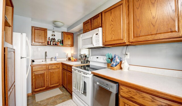 175 Pierson Blvd, Newark, OH 43055 - kitchen with white appliances, light countertops, brown cabinets, and open shelves