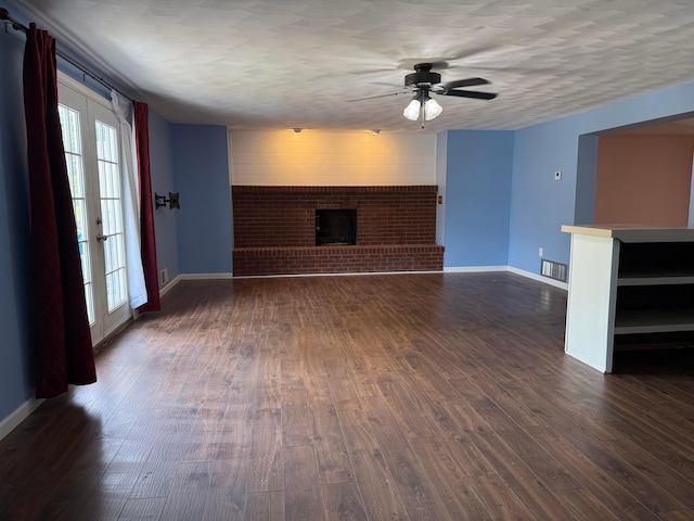 1628 Lucks Rd, Reynoldsburg, OH 43068 - unfurnished living room with a brick fireplace, a ceiling fan, and dark wood-type flooring