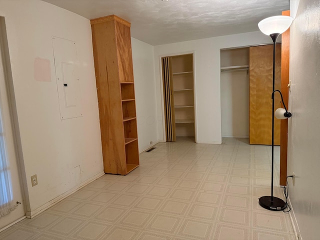 1628 Lucks Rd, Reynoldsburg, OH 43068 - unfurnished bedroom with multiple closets, light floors, and electric panel
