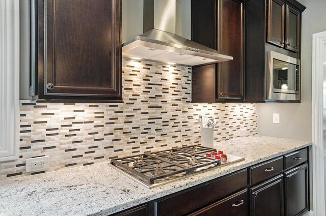 3860 Coldwater Loop, Powell, OH 43065 - kitchen with wall chimney exhaust hood, stainless steel appliances, decorative backsplash, and dark brown cabinetry