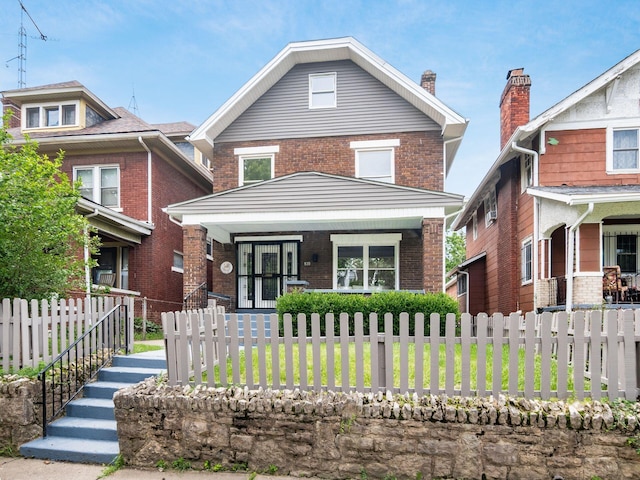 935 S Ohio Ave, Columbus, OH 43206 - traditional style home featuring covered porch, brick siding, and a fenced front yard
