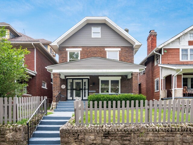 935 S Ohio Ave, Columbus, OH 43206 - traditional style home with covered porch, brick siding, and a fenced front yard