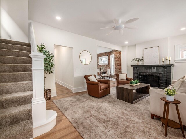 935 S Ohio Ave, Columbus, OH 43206 - living area featuring stairs, ceiling fan, light wood-style floors, a tiled fireplace, and recessed lighting