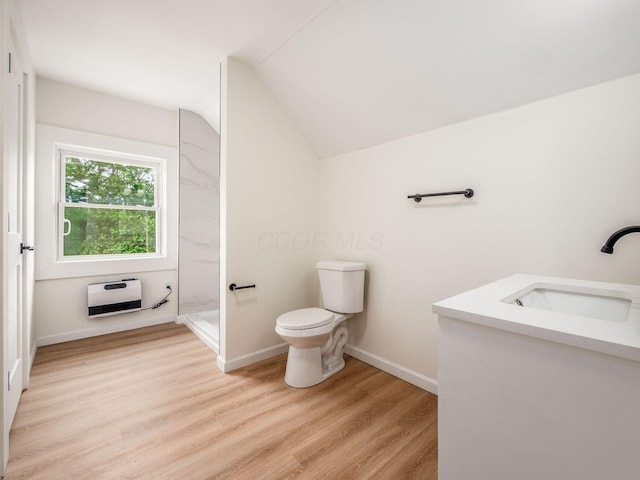 935 S Ohio Ave, Columbus, OH 43206 - full bathroom with vanity, heating unit, walk in shower, vaulted ceiling, and wood finished floors