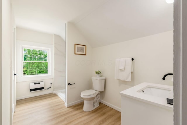 935 S Ohio Ave, Columbus, OH 43206 - full bathroom featuring heating unit, vaulted ceiling, vanity, wood finished floors, and a shower