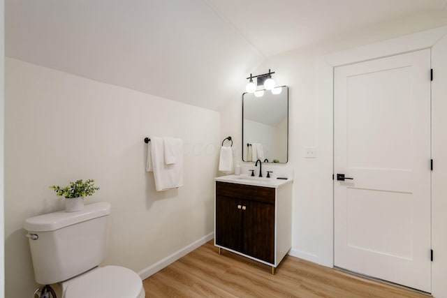 935 S Ohio Ave, Columbus, OH 43206 - half bathroom featuring wood finished floors, lofted ceiling, and vanity