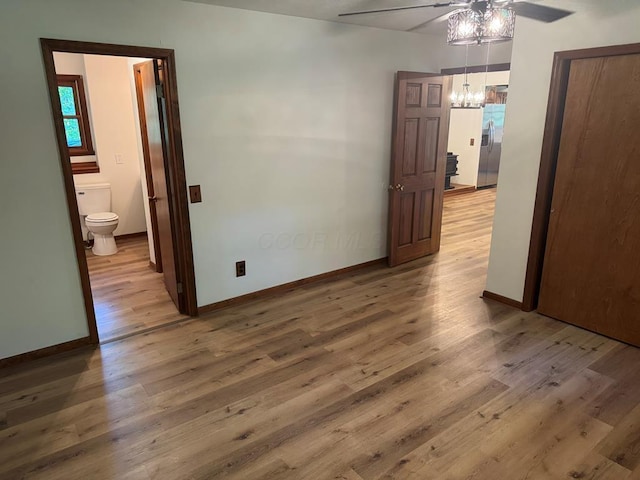 300 Core Rd, Frankfort, OH 45628 - spare room with a ceiling fan, a chandelier, and light wood-style floors