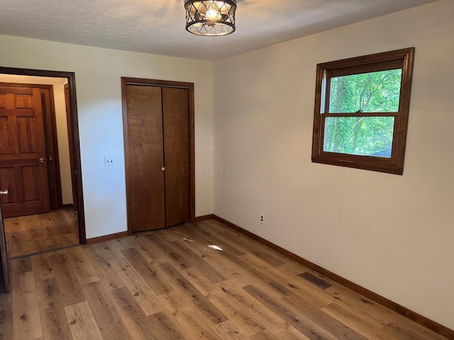 300 Core Rd, Frankfort, OH 45628 - unfurnished bedroom with light wood-style flooring, a closet, and a textured ceiling