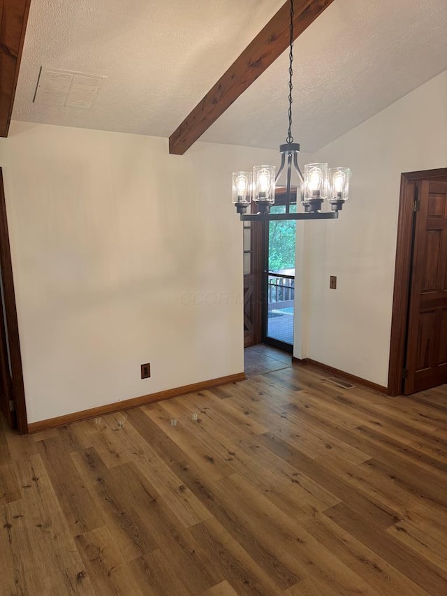300 Core Rd, Frankfort, OH 45628 - unfurnished dining area with a chandelier, wood-type flooring, beam ceiling, and a textured ceiling
