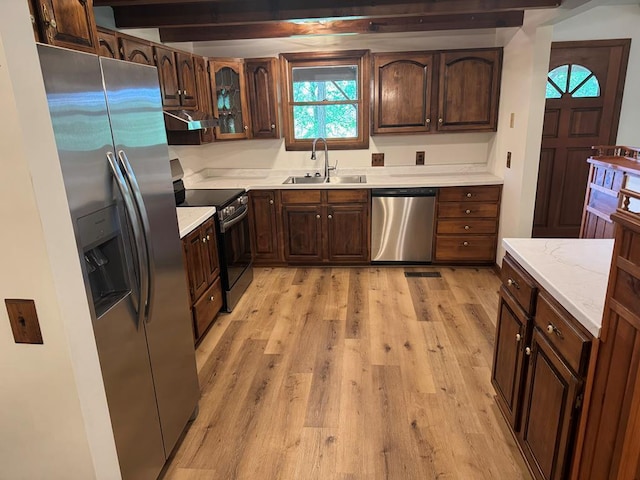 300 Core Rd, Frankfort, OH 45628 - kitchen with stainless steel appliances, under cabinet range hood, light wood finished floors, and dark brown cabinetry