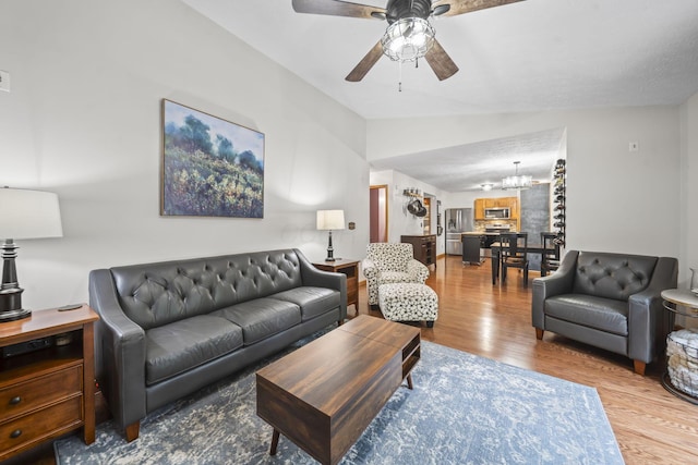 5528 Westerville Crossing Dr, Westerville, OH 43081 - living room featuring wood finished floors, vaulted ceiling, a chandelier, and a ceiling fan
