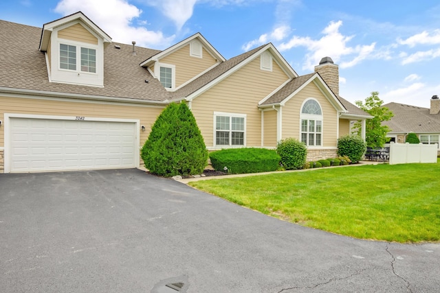 3242 Rossmore Cir, Powell, OH 43065 - view of front of house featuring asphalt driveway, a shingled roof, a chimney, and stone siding