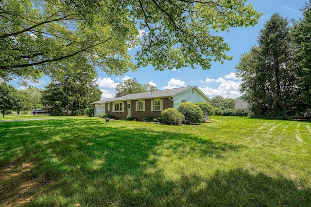4979 Johnanne Dr, Groveport, OH 43125 - view of front of property featuring a garage, a front yard, and brick siding