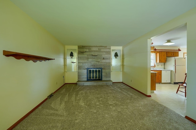 4979 Johnanne Dr, Groveport, OH 43125 - unfurnished living room featuring light colored carpet and a fireplace