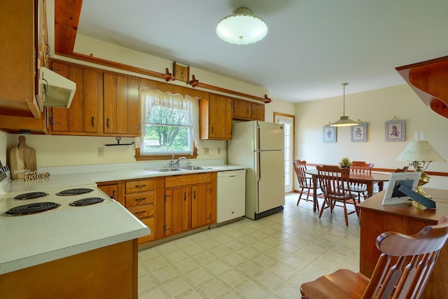 4979 Johnanne Dr, Groveport, OH 43125 - kitchen featuring white appliances, exhaust hood, brown cabinets, light countertops, and light flooring