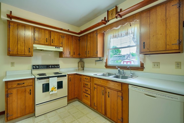 4979 Johnanne Dr, Groveport, OH 43125 - kitchen featuring white appliances, under cabinet range hood, brown cabinetry, and light countertops