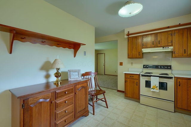 4979 Johnanne Dr, Groveport, OH 43125 - kitchen with white electric range, under cabinet range hood, and brown cabinetry