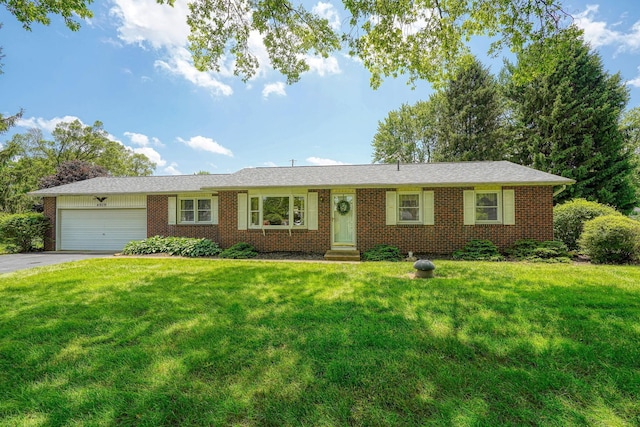 4979 Johnanne Dr, Groveport, OH 43125 - ranch-style home with entry steps, a garage, driveway, brick siding, and a front yard