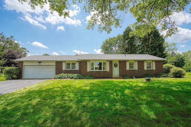 4979 Johnanne Dr, Groveport, OH 43125 - single story home featuring a garage, asphalt driveway, brick siding, and a front yard