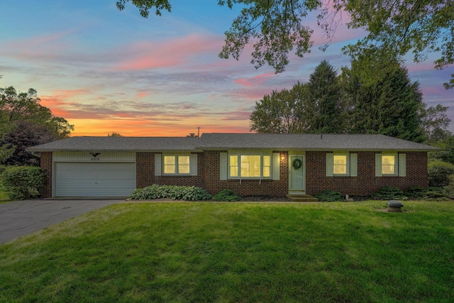4979 Johnanne Dr, Groveport, OH 43125 - ranch-style house featuring a garage, driveway, brick siding, and a lawn