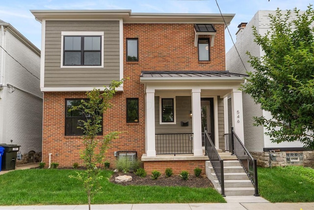 546 W Town St, Columbus, OH 43215 - view of front facade with brick siding, a standing seam roof, a front yard, and a porch