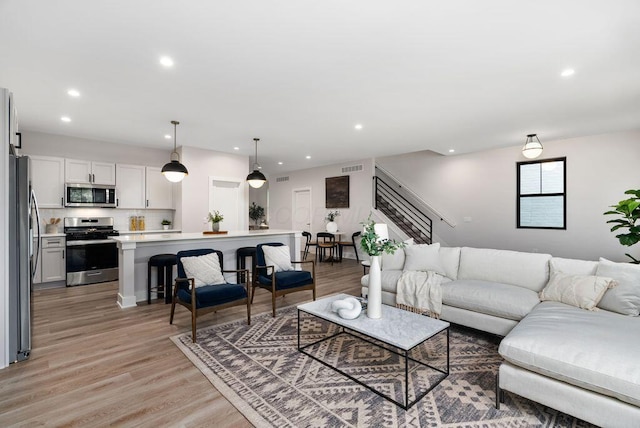 546 W Town St, Columbus, OH 43215 - living room featuring stairs, recessed lighting, and light wood-style flooring
