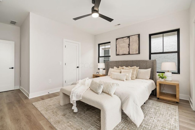 546 W Town St, Columbus, OH 43215 - bedroom featuring multiple windows, wood finished floors, and ceiling fan