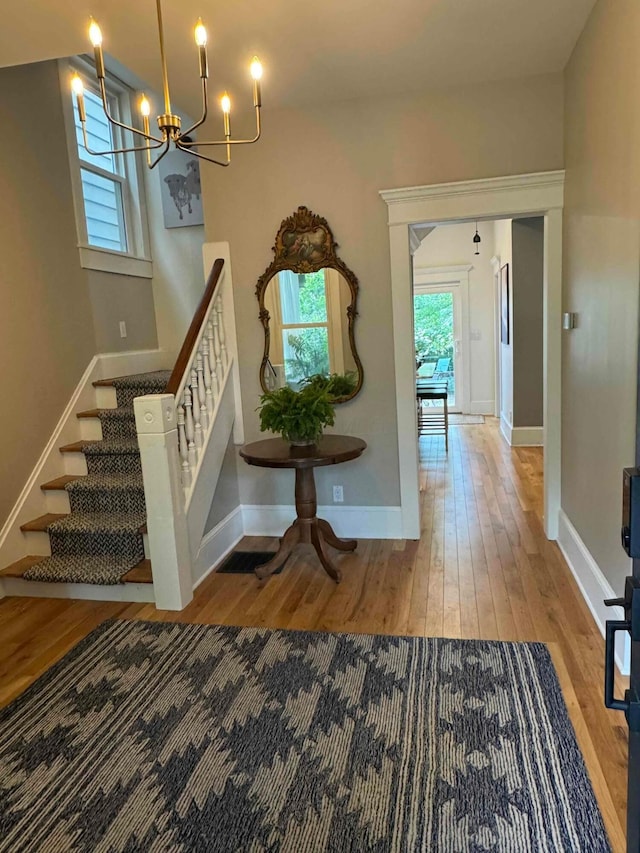 489 W 4th Ave, Columbus, OH 43201 - entrance foyer featuring hardwood / wood-style flooring, a chandelier, and stairs