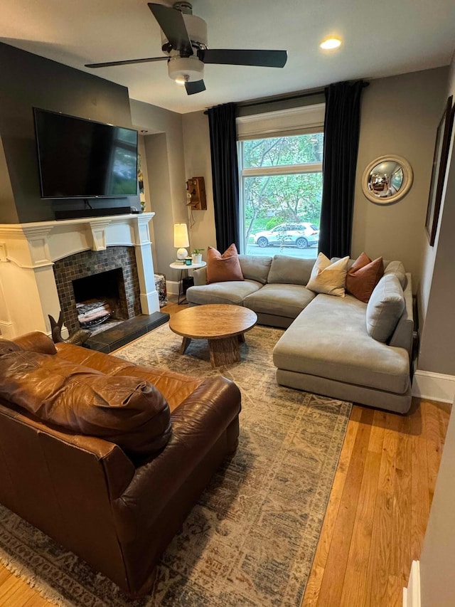 489 W 4th Ave, Columbus, OH 43201 - living room featuring hardwood / wood-style flooring, a ceiling fan, a tile fireplace, and recessed lighting