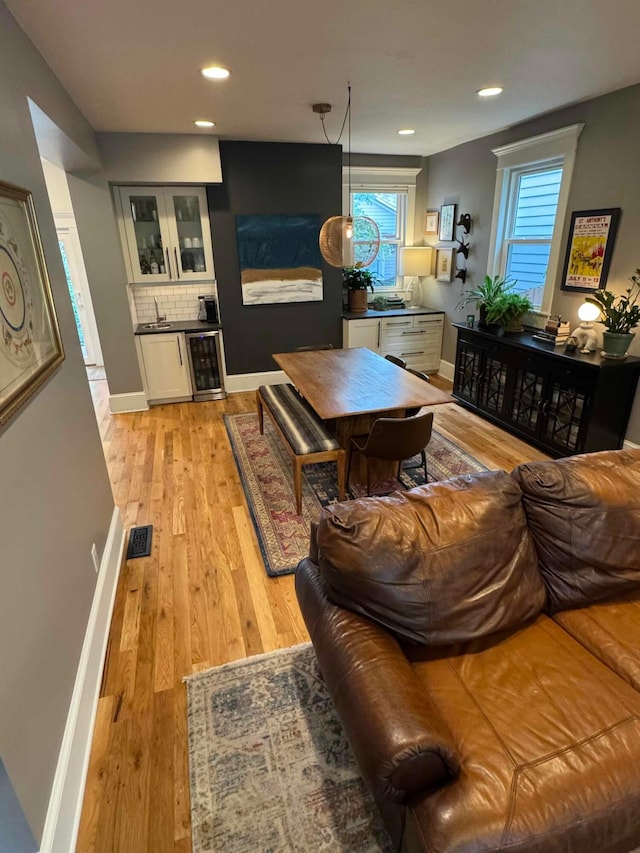 489 W 4th Ave, Columbus, OH 43201 - living area with wine cooler, healthy amount of natural light, light wood-style flooring, and recessed lighting