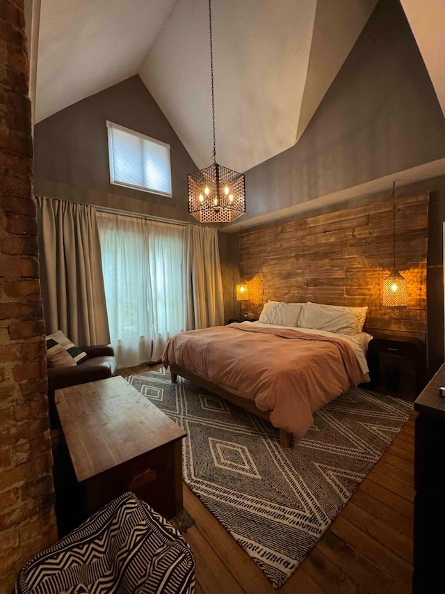 489 W 4th Ave, Columbus, OH 43201 - bedroom with high vaulted ceiling, hardwood / wood-style floors, and a chandelier
