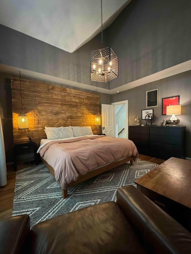 489 W 4th Ave, Columbus, OH 43201 - bedroom featuring wood finished floors, a chandelier, and high vaulted ceiling