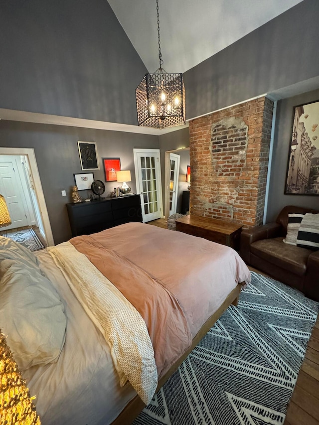 489 W 4th Ave, Columbus, OH 43201 - bedroom with a towering ceiling, a chandelier, wood finished floors, and french doors