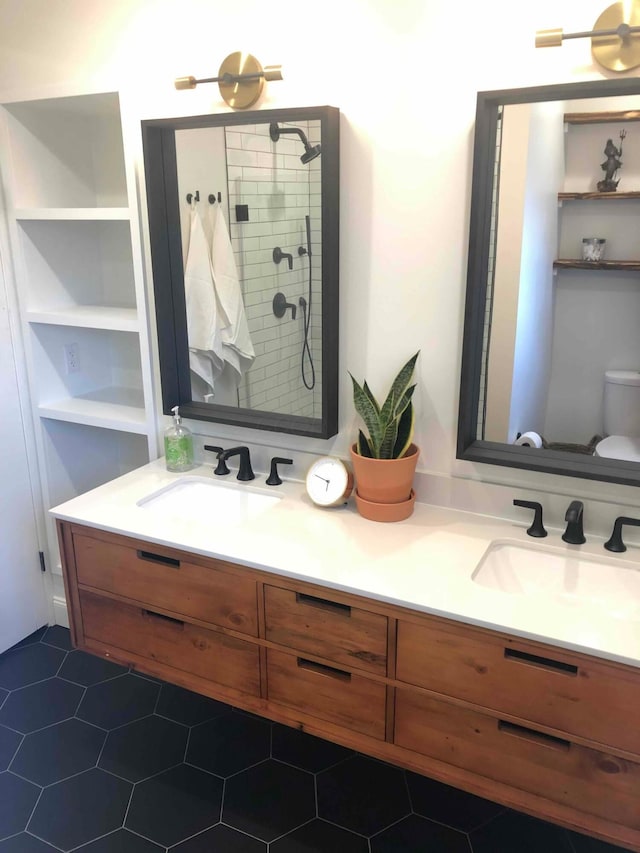 489 W 4th Ave, Columbus, OH 43201 - bathroom featuring double vanity, a tile shower, and tile patterned floors