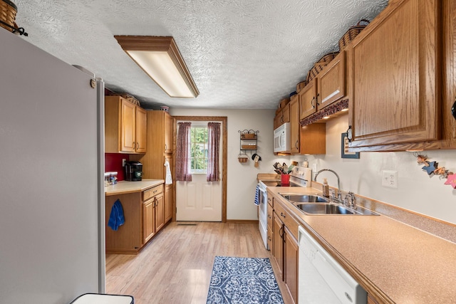 6492 Cherokee Rose Dr, Westerville, OH 43081 - kitchen with white appliances, light wood-type flooring, light countertops, a textured ceiling, and brown cabinets
