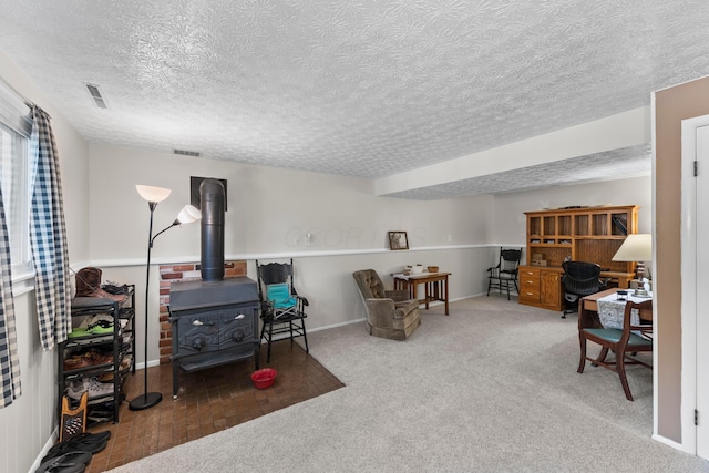 6492 Cherokee Rose Dr, Westerville, OH 43081 - living area with a textured ceiling, a wood stove, carpet floors, and a desk