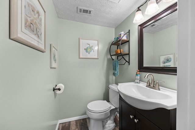 6492 Cherokee Rose Dr, Westerville, OH 43081 - half bath featuring vanity, wood finished floors, and a textured ceiling