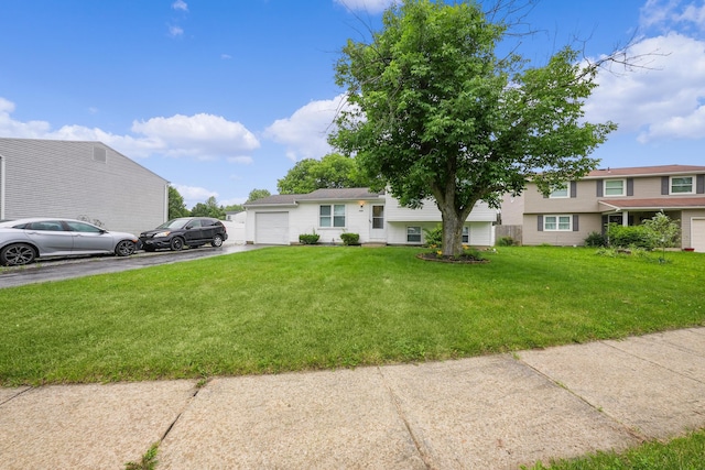 1310 Sweetbay Pl, Galloway, OH 43119 - view of front of house with asphalt driveway, a garage, and a front lawn
