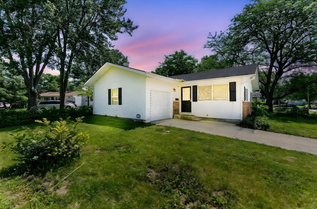 1894 Orlando Rd, Columbus, OH 43232 - ranch-style house with a garage, concrete driveway, a yard, and stucco siding