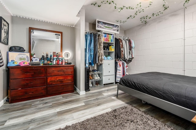 784 Brevard Cir, Pickerington, OH 43147 - bedroom featuring concrete block wall, wood finished floors, and a closet