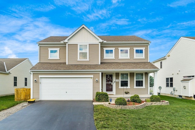 208 Dowler Dr, South Bloomfield, OH 43103 - view of front of house featuring covered porch, asphalt driveway, an attached garage, a front yard, and a shingled roof