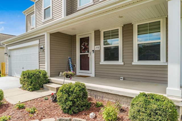 208 Dowler Dr, South Bloomfield, OH 43103 - entrance to property featuring a porch, an attached garage, and driveway