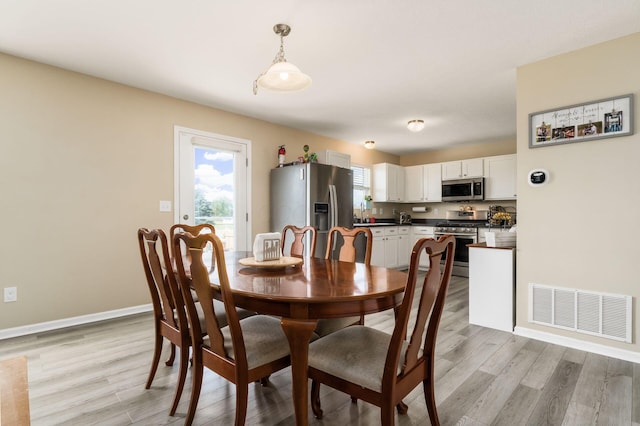 208 Dowler Dr, South Bloomfield, OH 43103 - dining area featuring light wood-style floors and baseboards