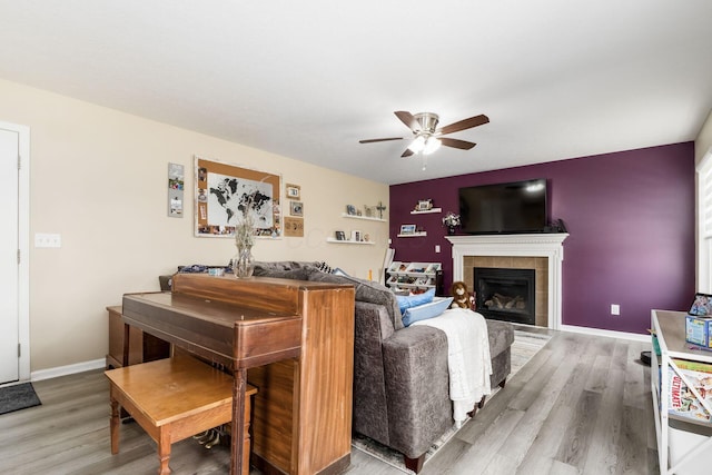 208 Dowler Dr, South Bloomfield, OH 43103 - living room with a ceiling fan, light wood finished floors, and a tiled fireplace
